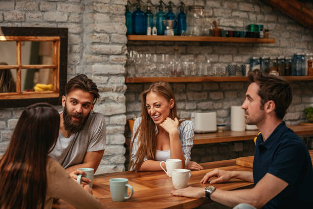 Group of friends chatting over coffee at work: catch-up meetings