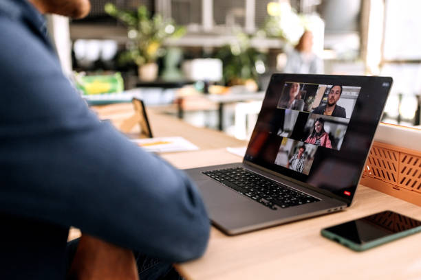 Close up of businessman having online meeting in the office. Meeting Check-In Questions