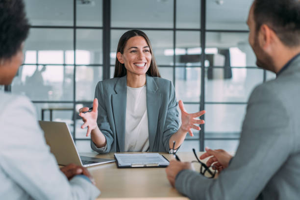 Shot of group of business persons in business meeting. Three entrepreneurs on meeting in board room. Corporate business sales team on meeting in modern office. What Does a Salesperson's Day Look Like With and Without Weezly?