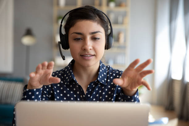  woman wear wireless headset video conference calling on laptop computer talk by webcam learn teach in online chat, Video Sales Training