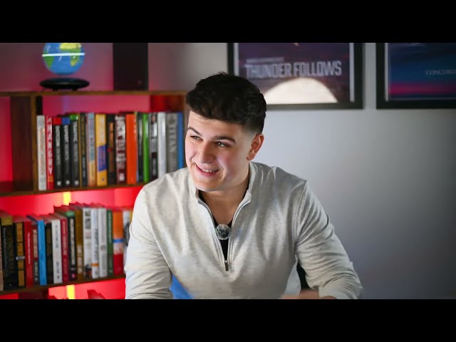 Agency leadership coaching team members while reviewing live results and system improvements in an open office.